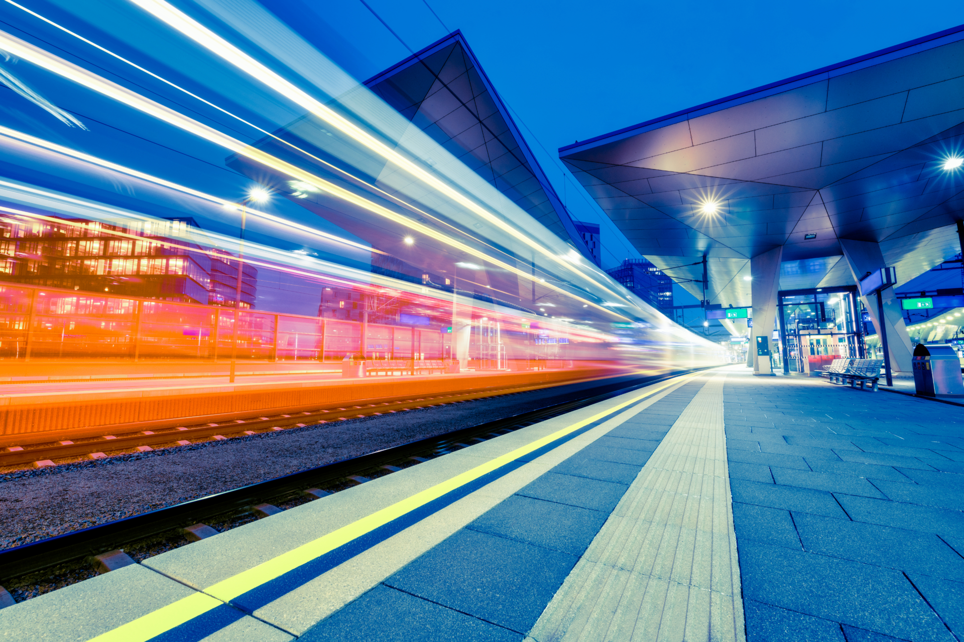 High-speed train at modern station with dynamic light trails, emphasizing rail transportation and ad.